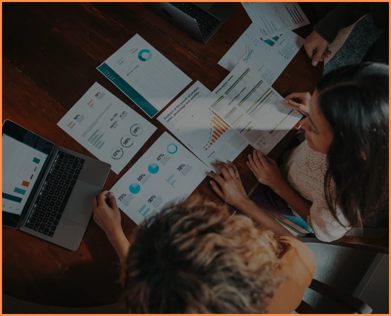 Colleagues reviewing statistical documents together